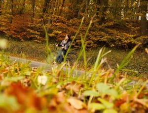 woman sitting on bicycle near road thumbnail
