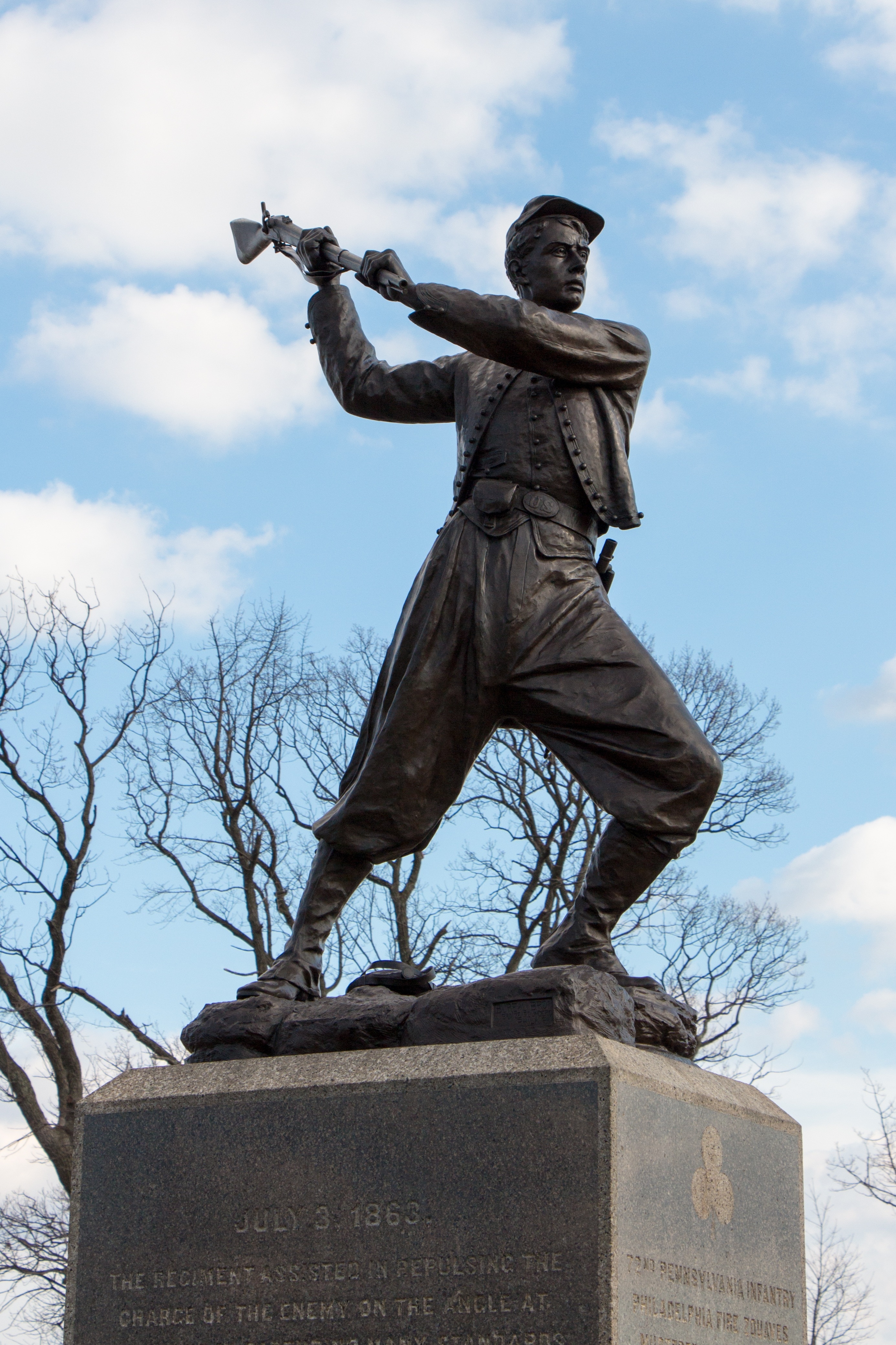 man holding rifle statue