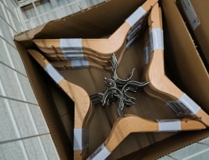 silver and brown wooden clothes hanger in box thumbnail