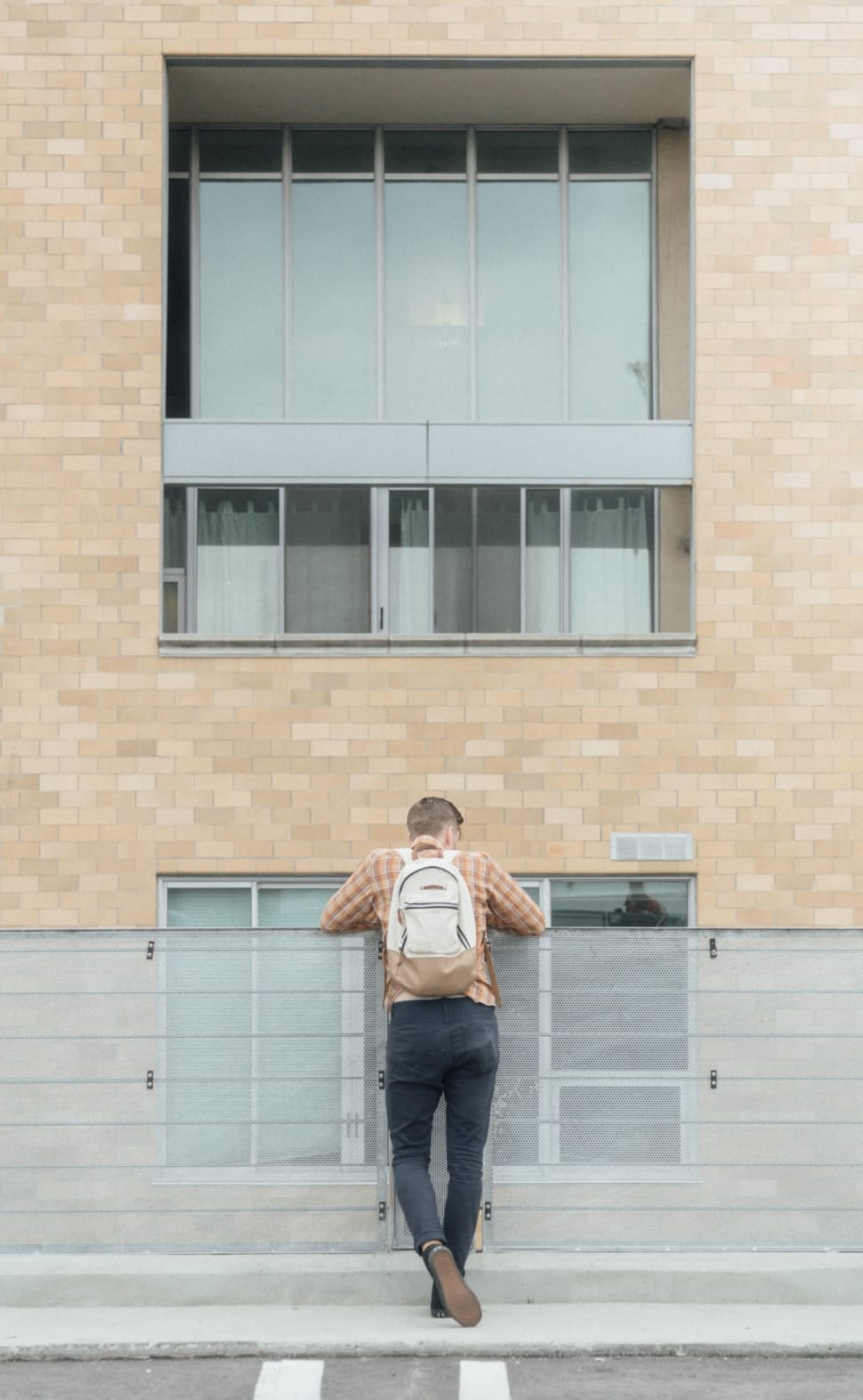 man standing infront of building during daytime preview