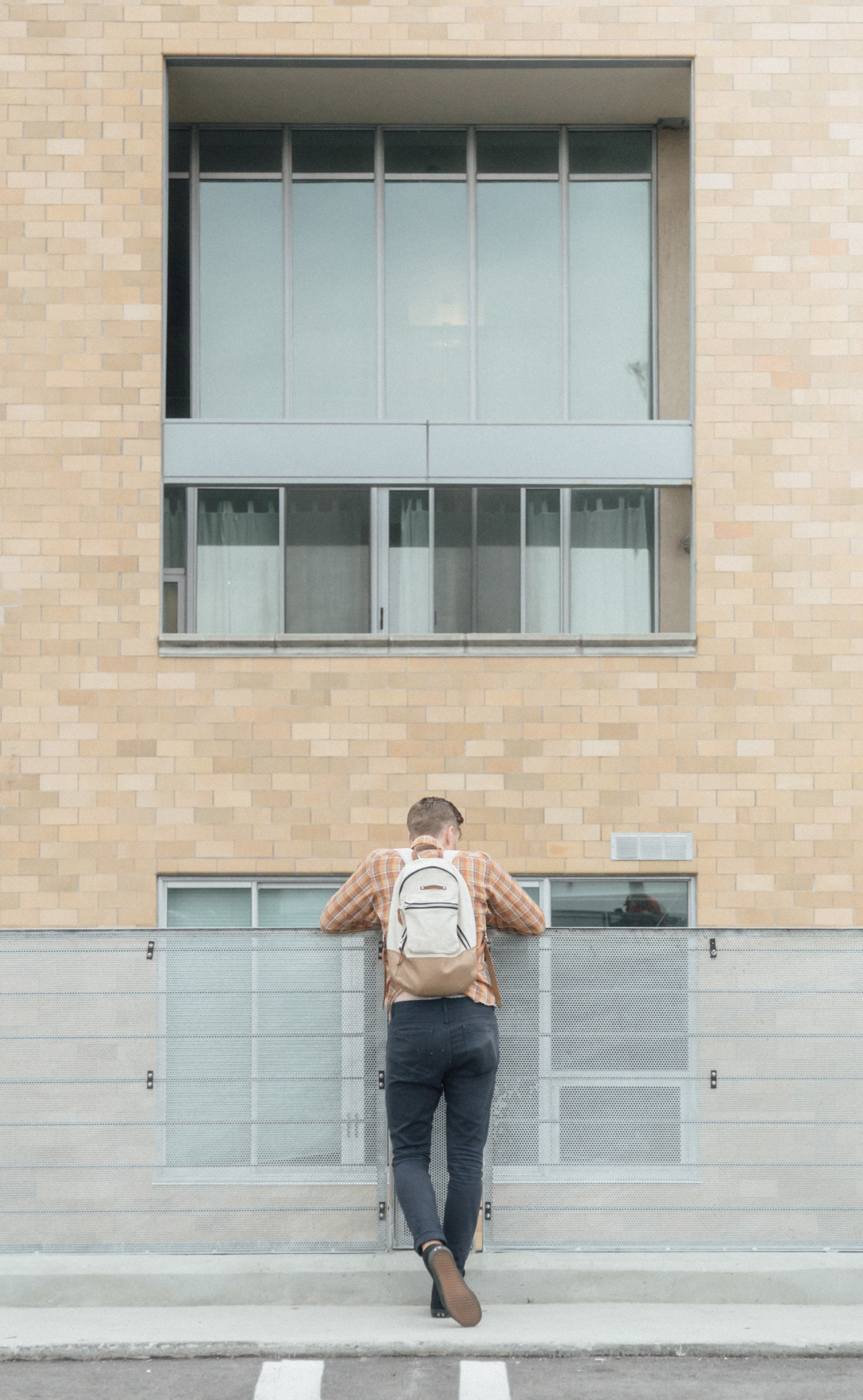 man standing infront of building during daytime