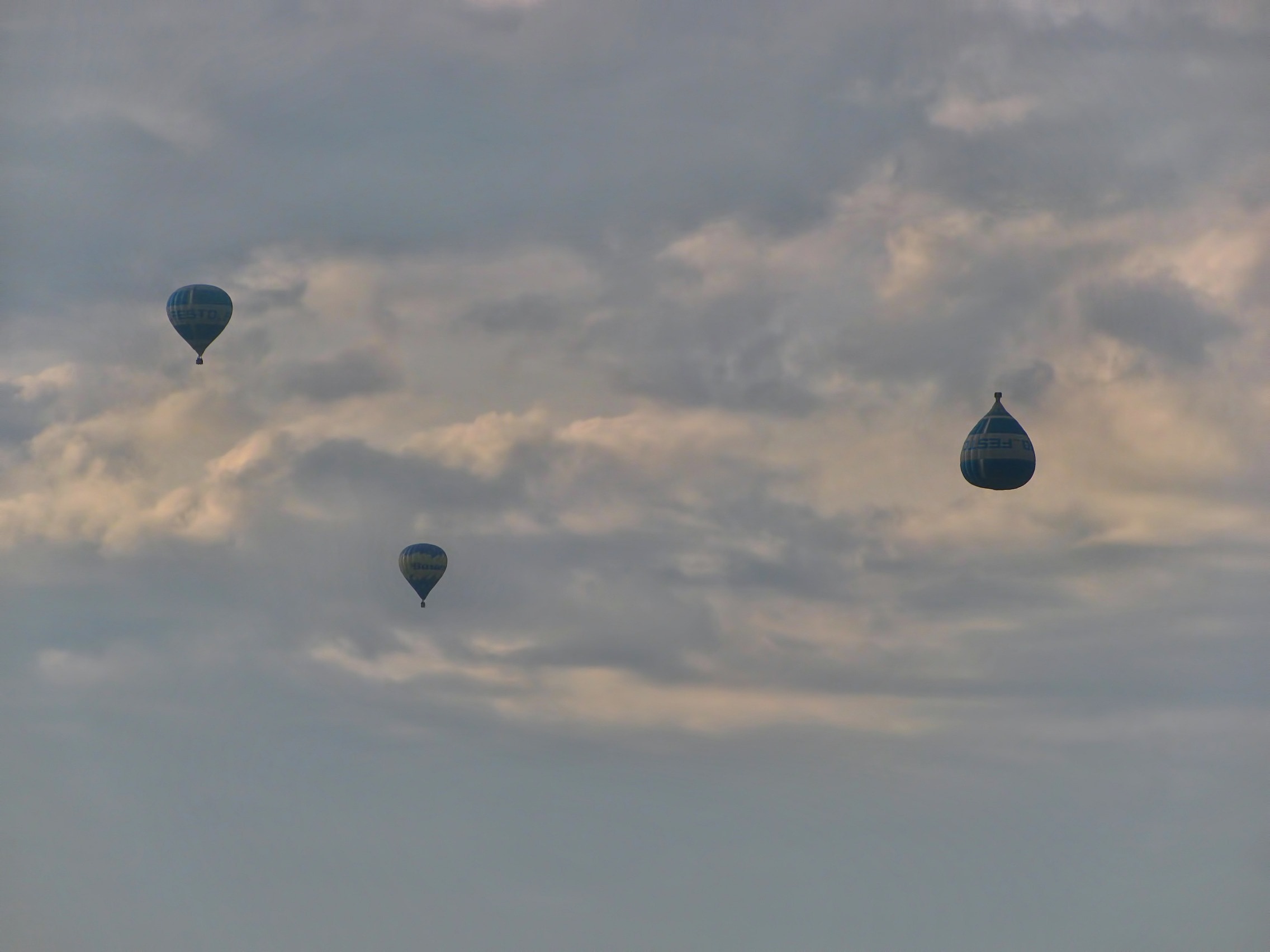 three gray hot air balloons
