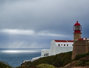 photography of lighthouse near body of water thumbnail