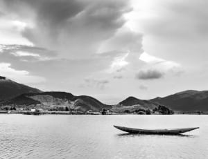 boat sailing on the body of water in grayscale photo thumbnail