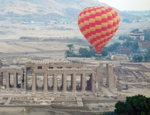 red and yellow hot air balloon and concrete infrastructure thumbnail