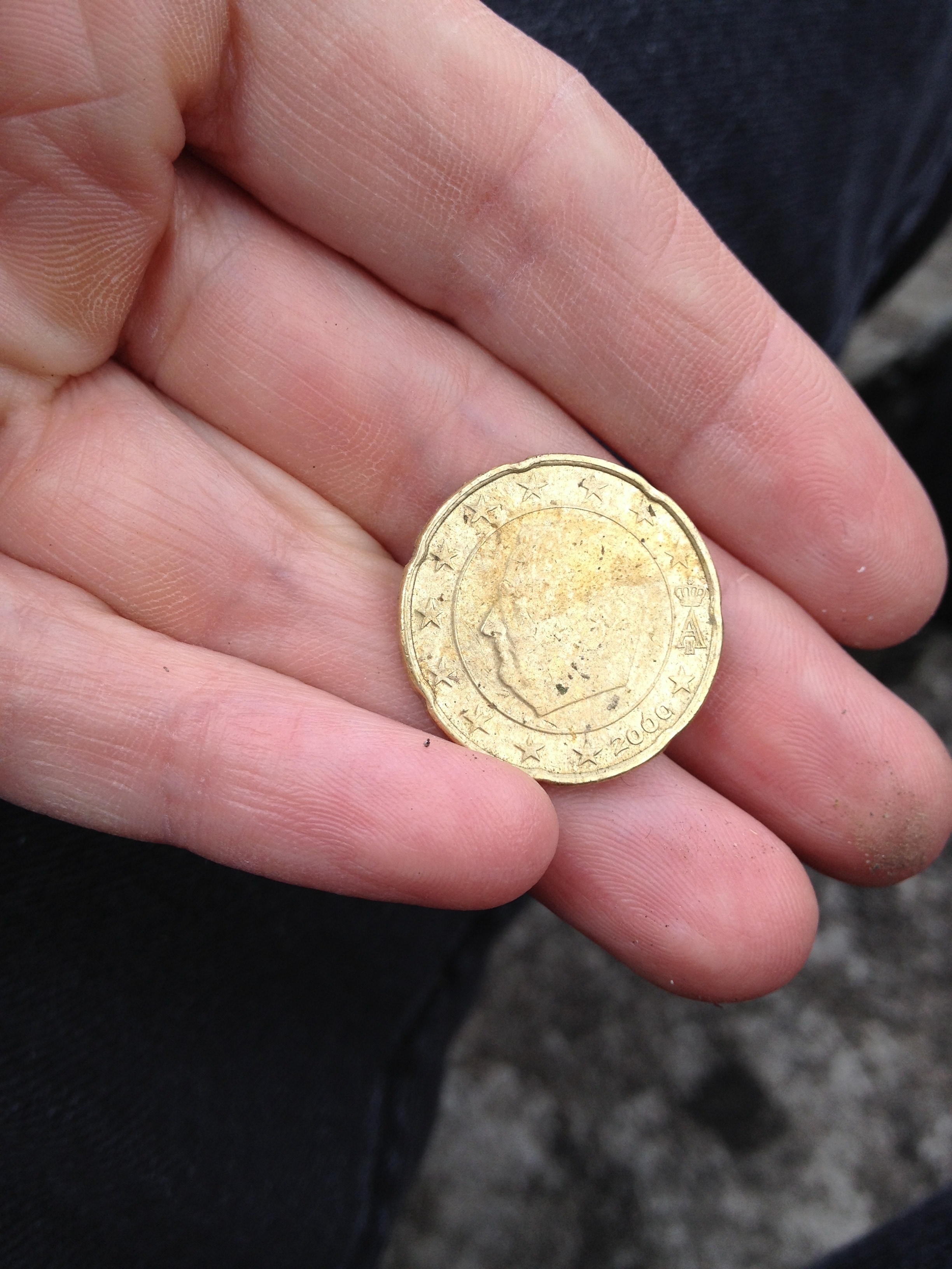 person holding round coin