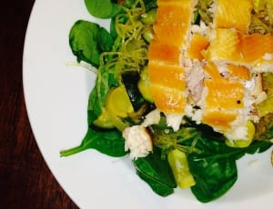 salmon and green vegetable salad on white ceramic plate thumbnail
