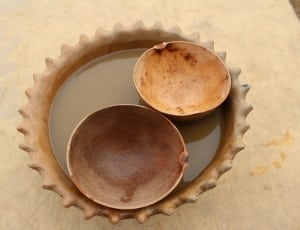 two brown round wooden bowls thumbnail