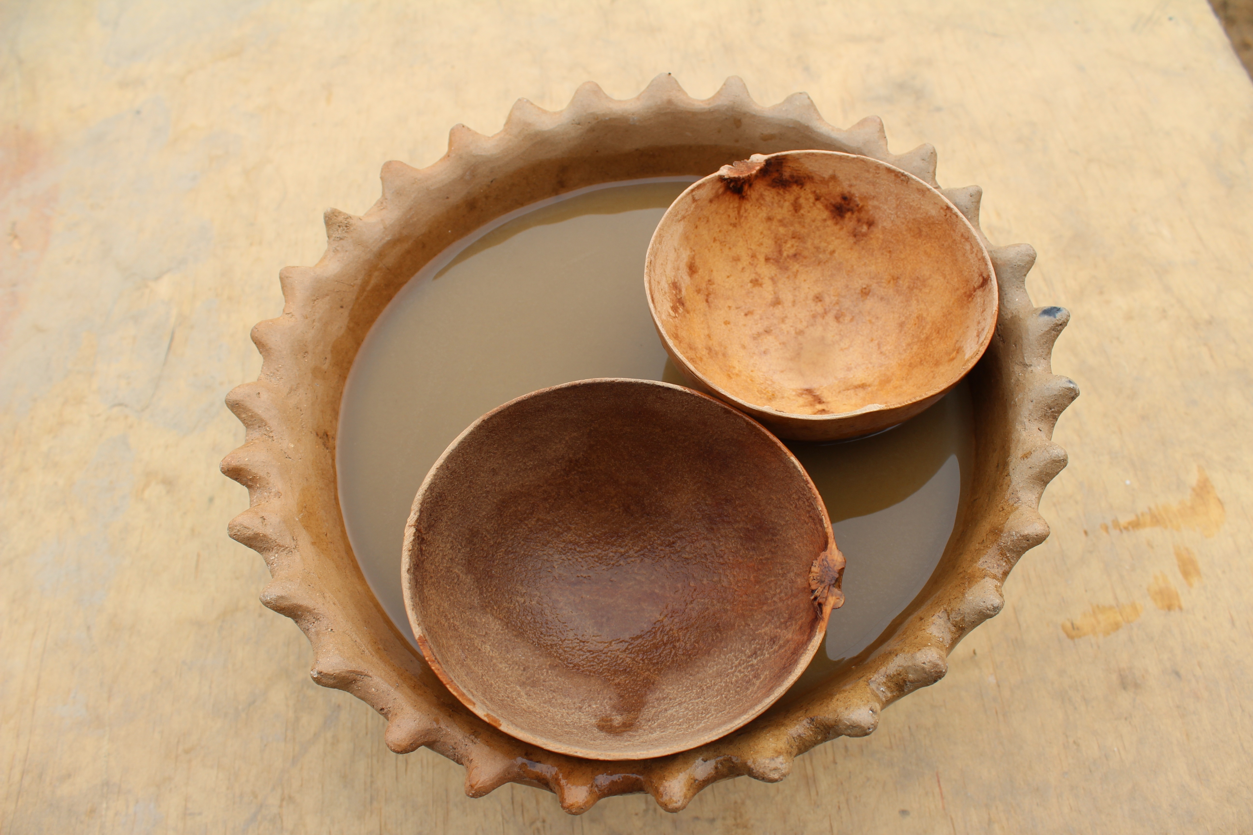 two brown round wooden bowls
