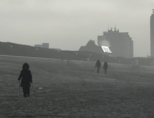 people walking on a foggy beach thumbnail