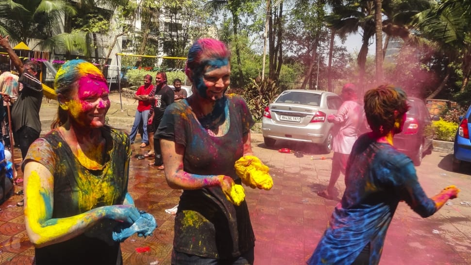 three people during a holi festival preview