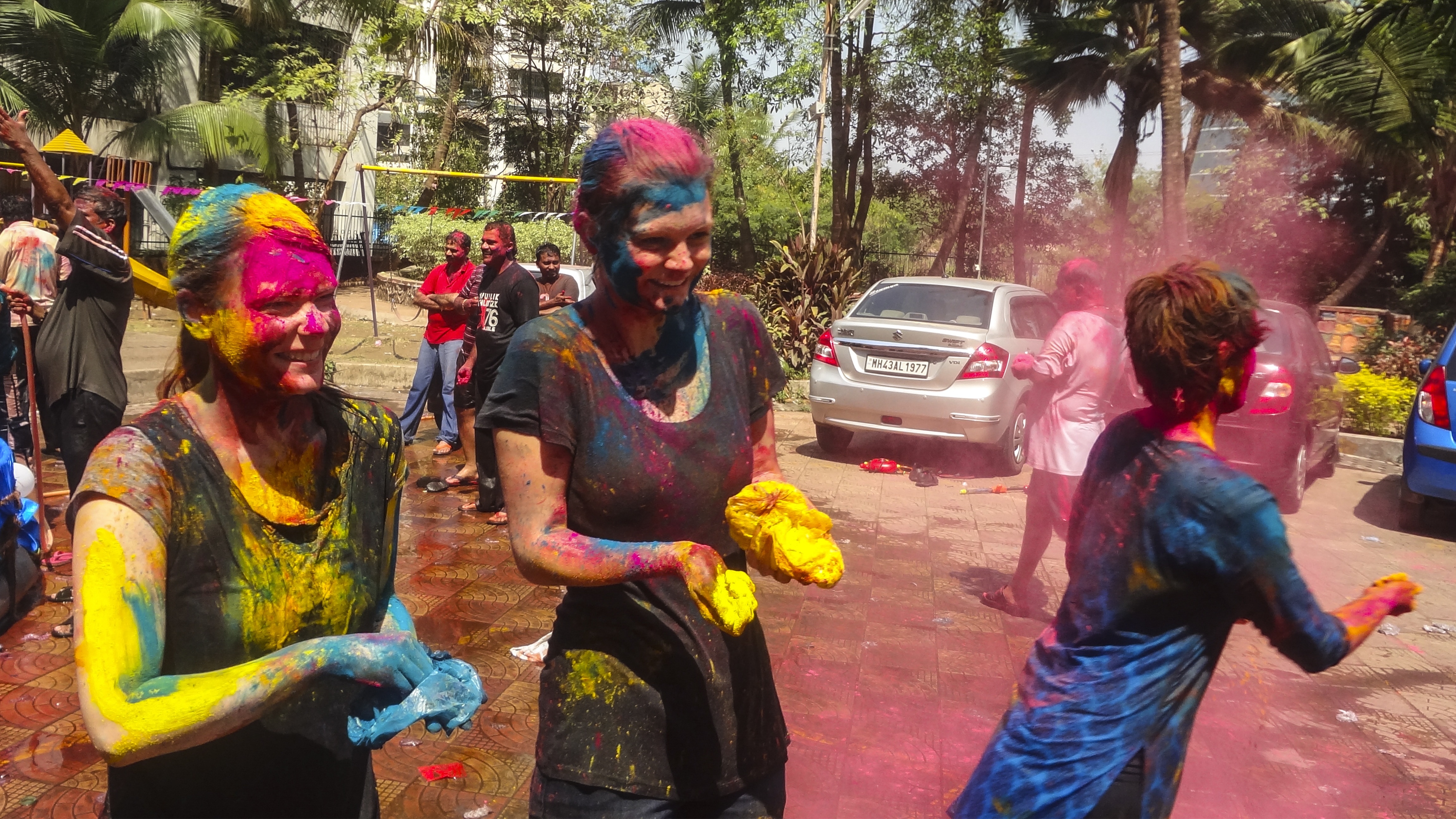 three people during a holi festival