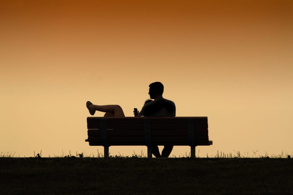 silhouette of man sitting on bench preview
