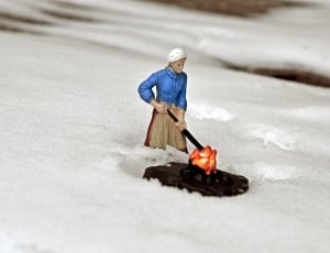 woman with blue blouse and brown skirt figurine thumbnail
