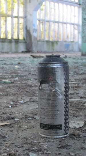 gray and black spray can on gray surface thumbnail