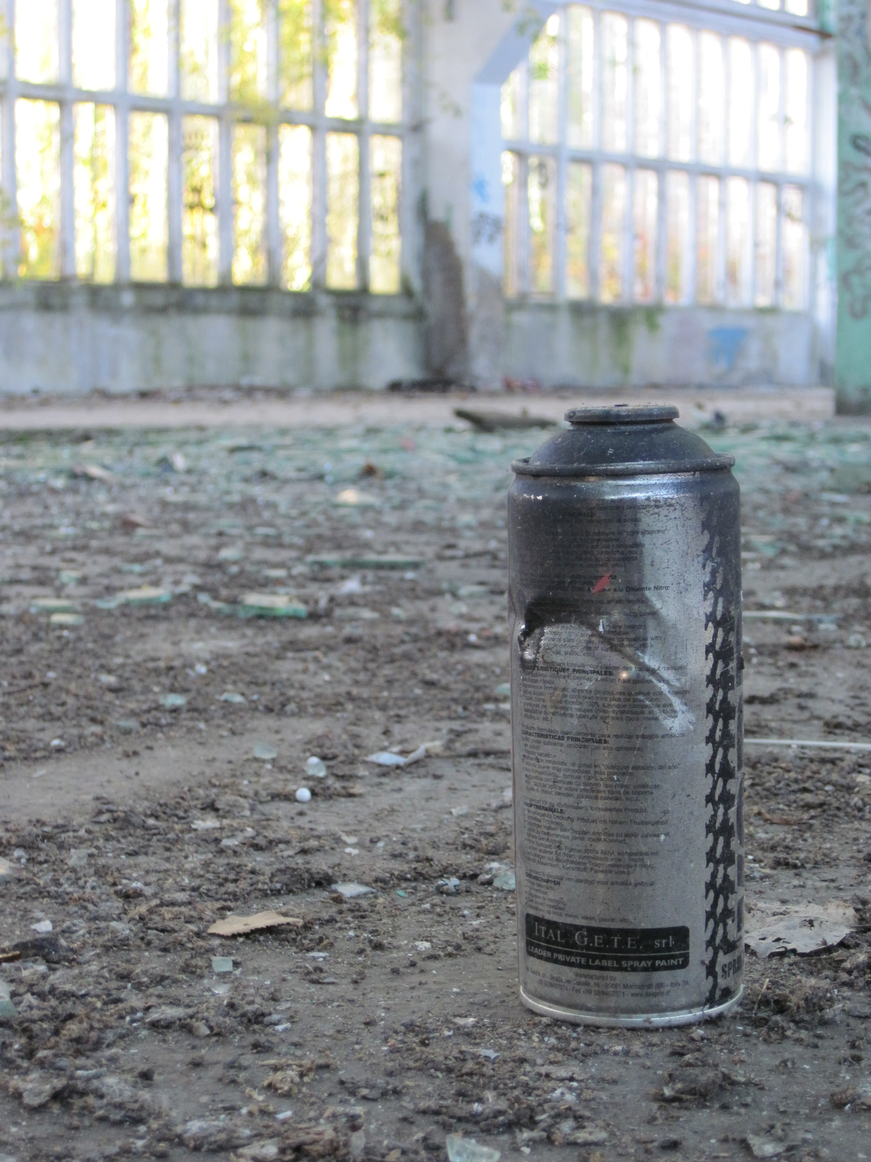 gray and black spray can on gray surface