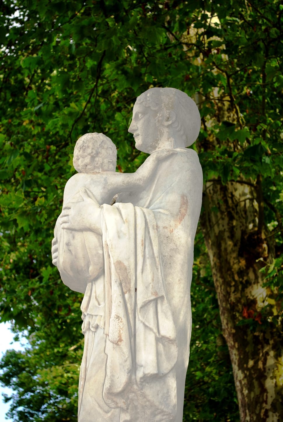 religious woman carrying a child statue preview