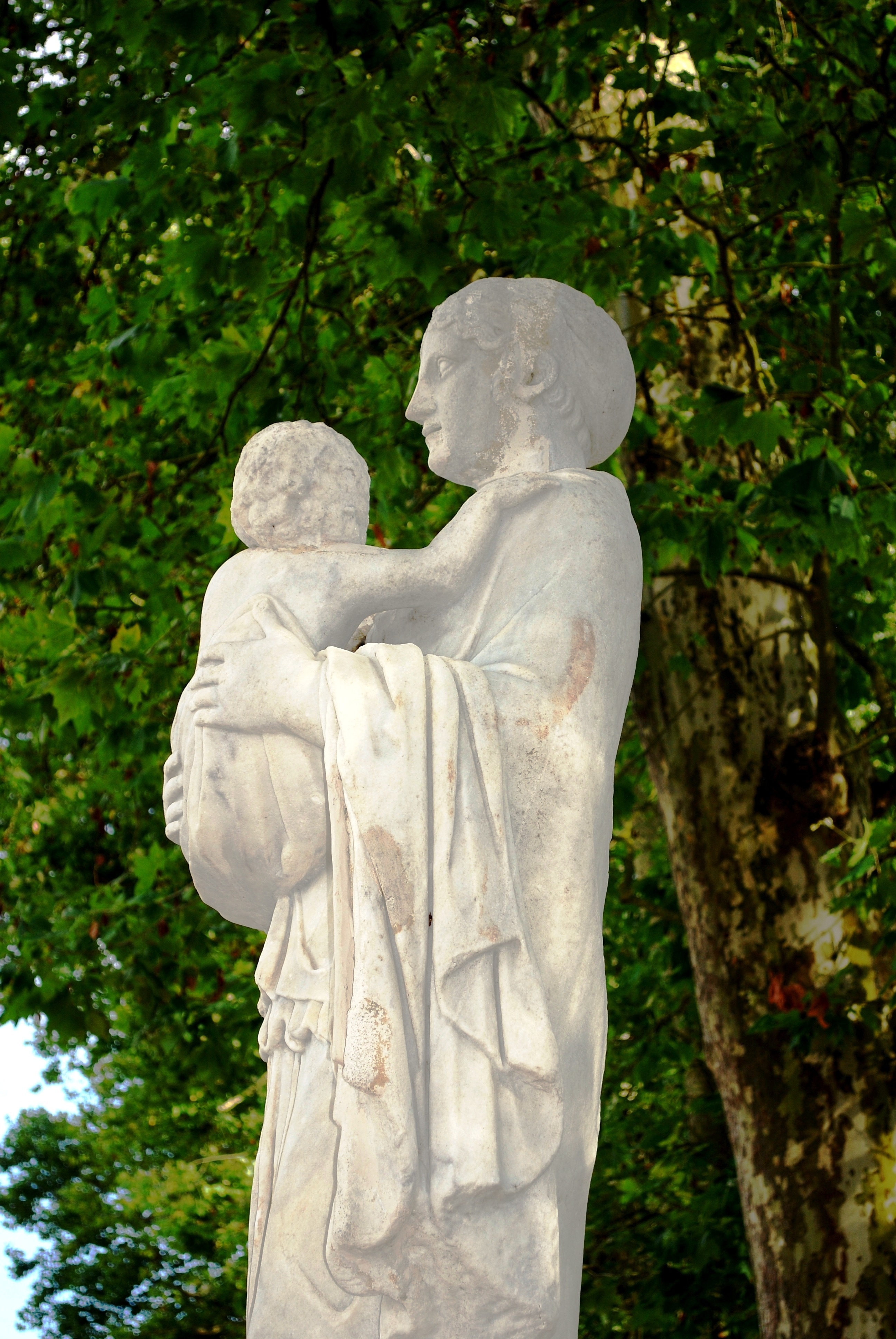 religious woman carrying a child statue