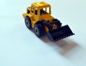 toddler's yellow and black front loader toy thumbnail