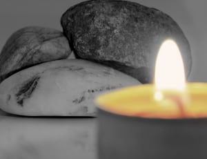 three stone near lighted candle thumbnail