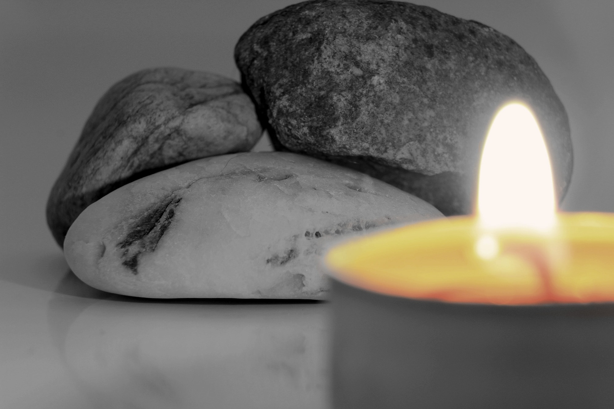 three stone near lighted candle
