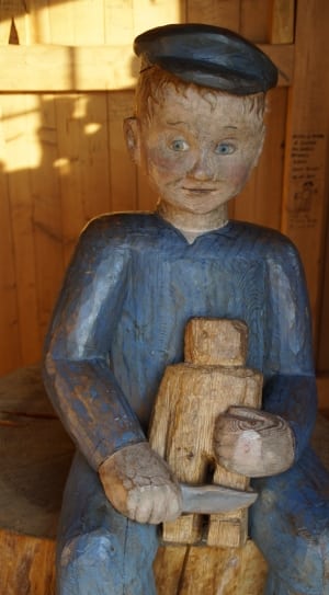blue and brown wooden clothes on boy figurine thumbnail