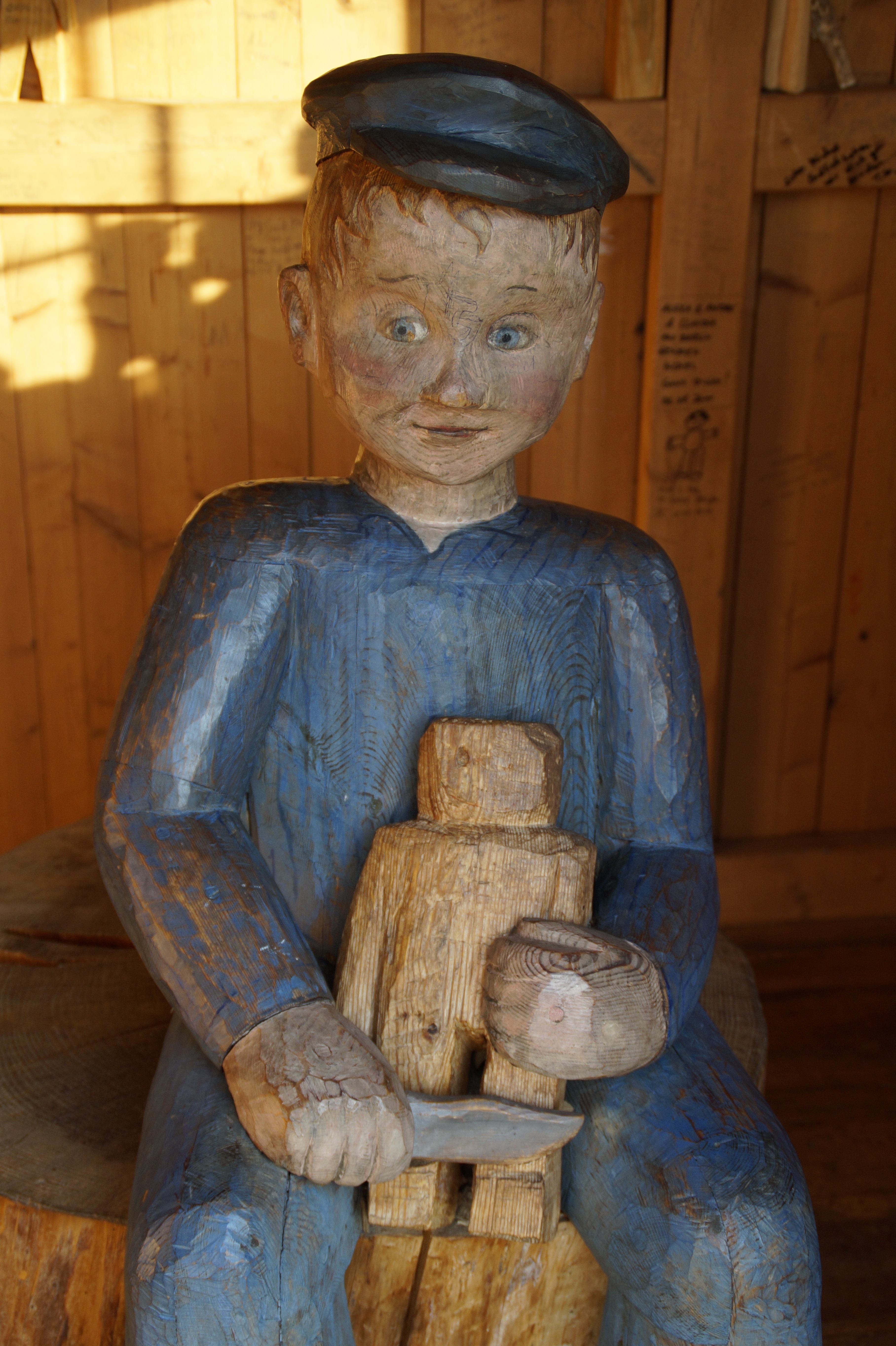 blue and brown wooden clothes on boy figurine