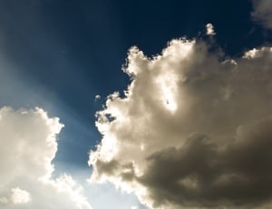 whte cloud behind sun during daytime thumbnail