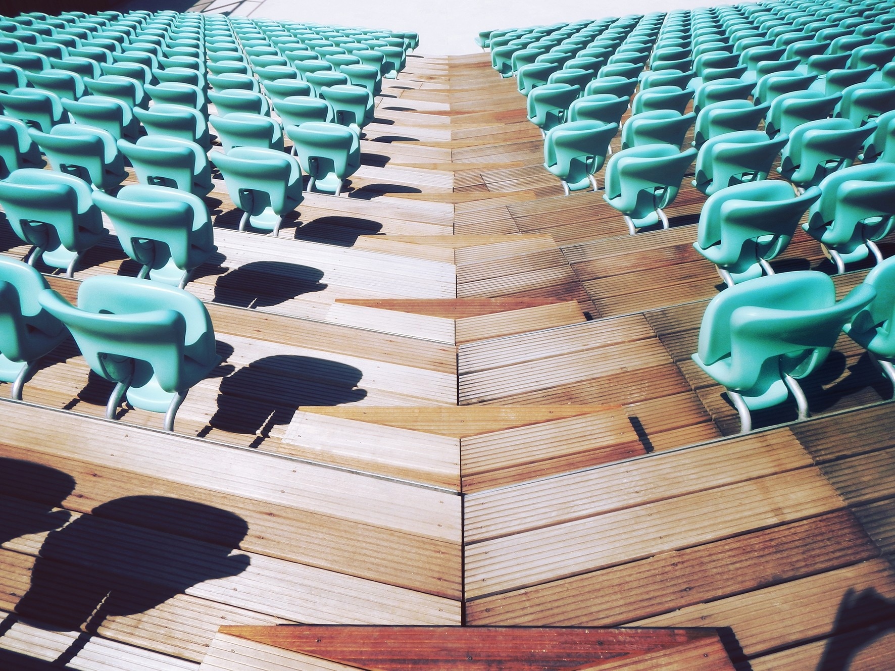 photo of aligned green chairs on brown hardwood floor