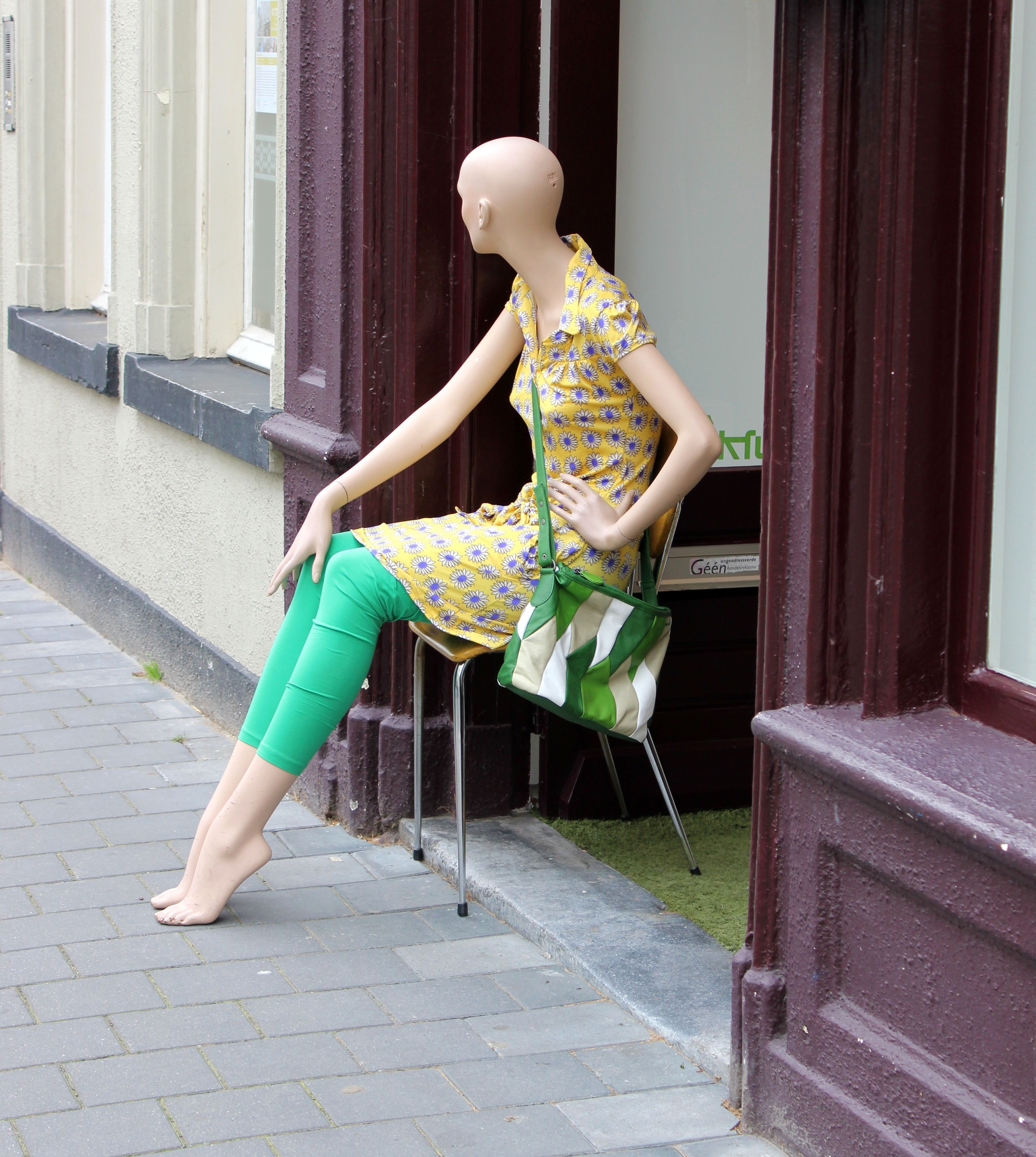 women's yellow and blue floral button up shirt dress and green leggings with sling bag