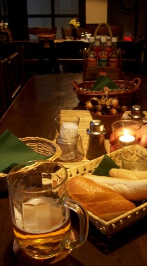 thee bread on basket near bear mug on table top thumbnail