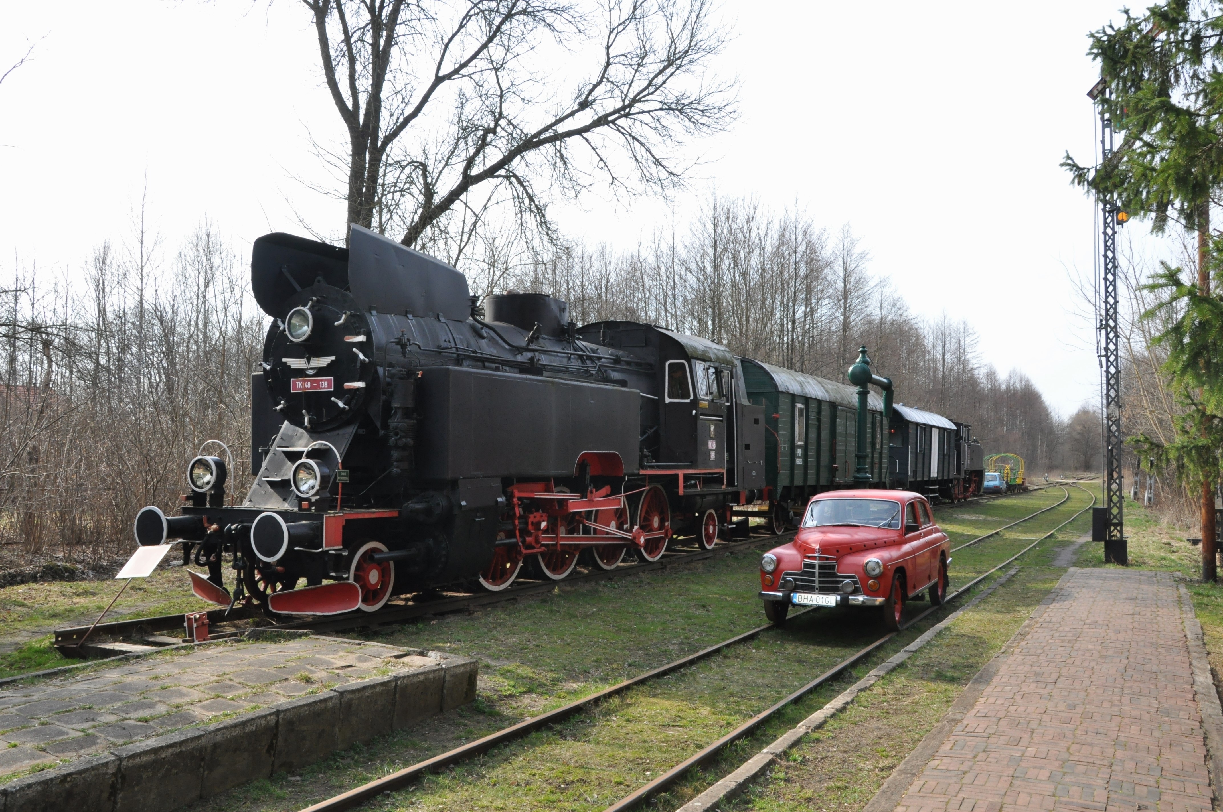 black charcoal train and red classic car