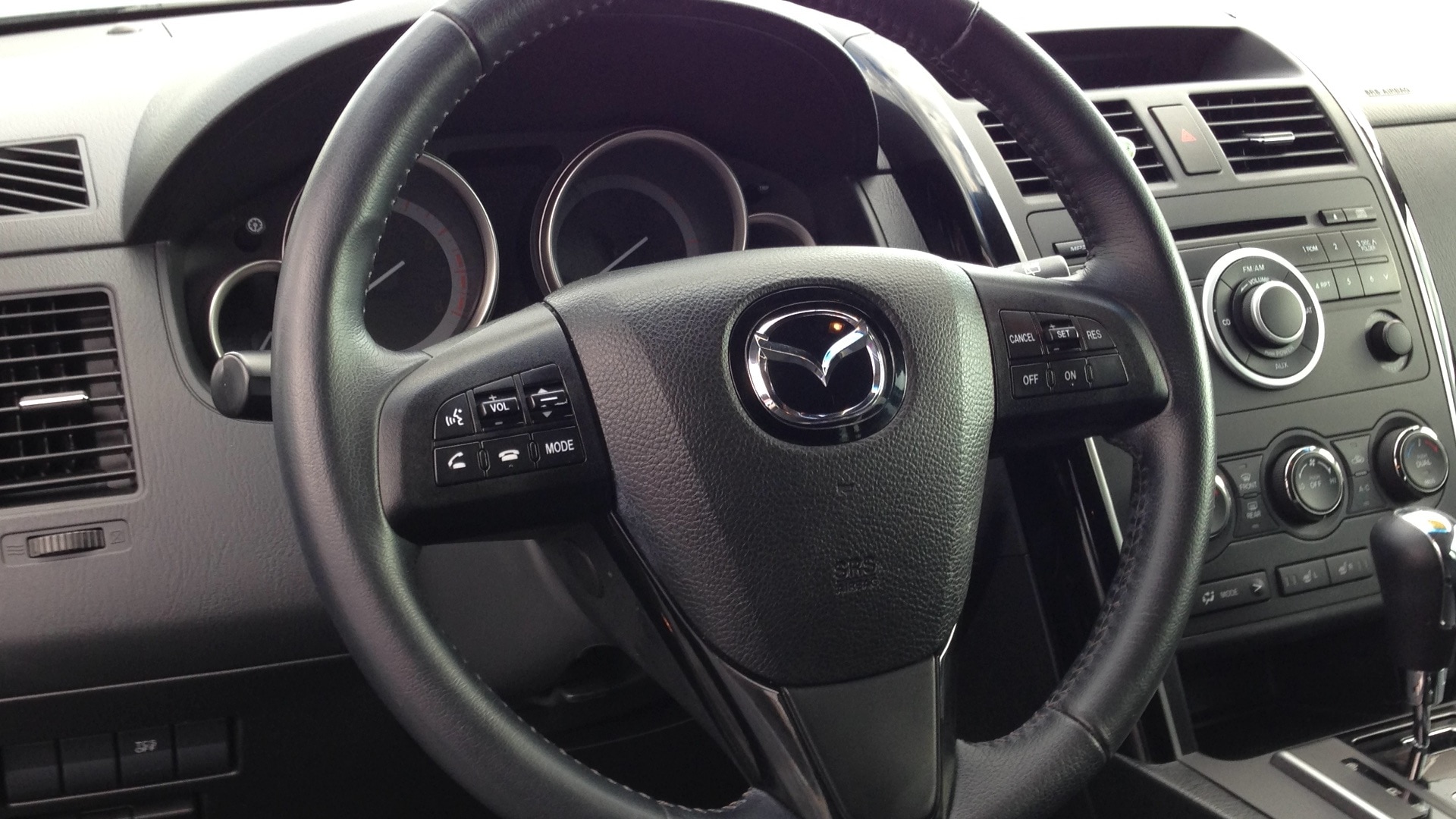 black mazda multi function steering wheel
