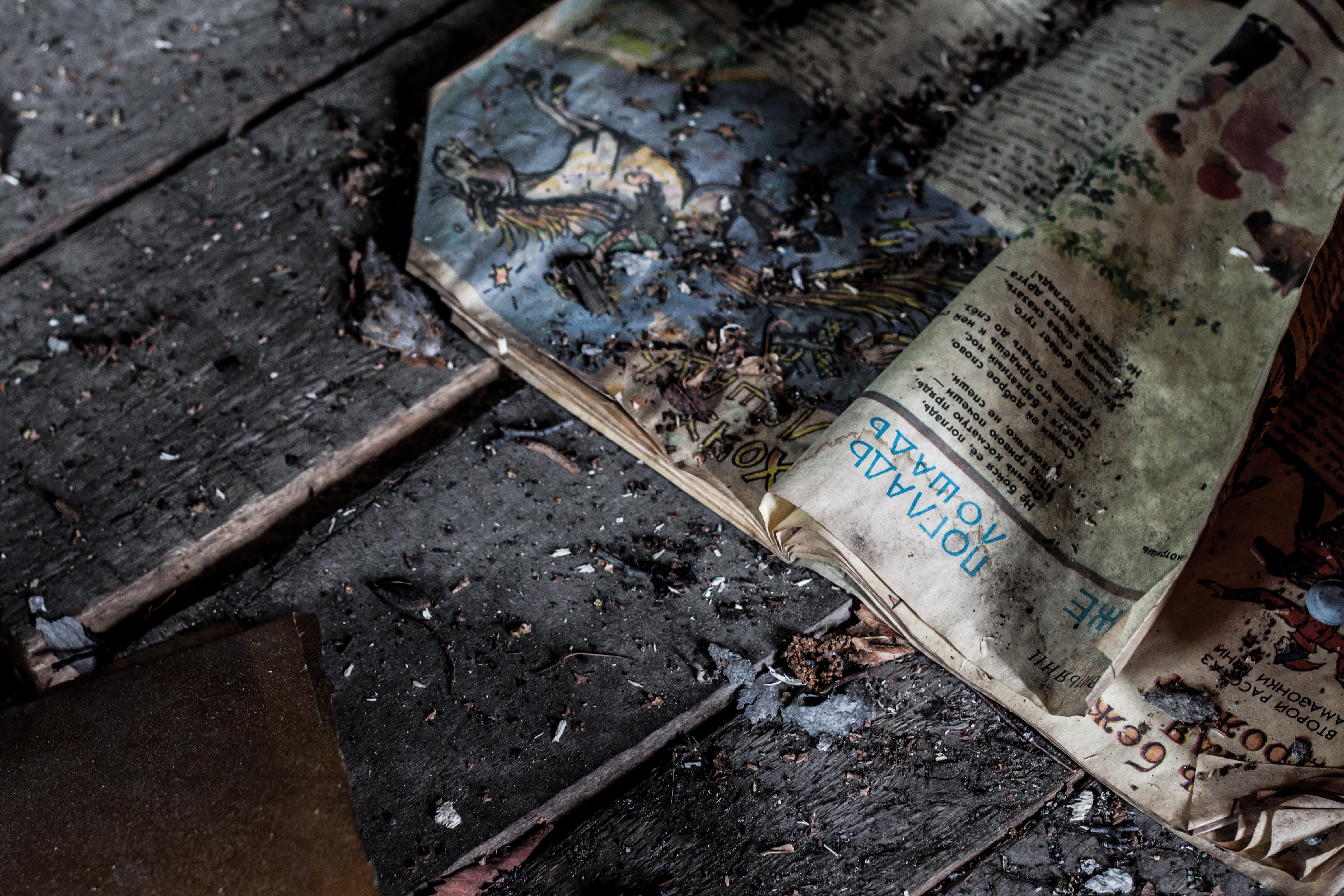 burned book on a grey wooden surface