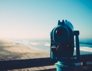 blue landmark viewing telescope pointing at seashore at daytime thumbnail
