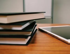 white tablet computer and books thumbnail