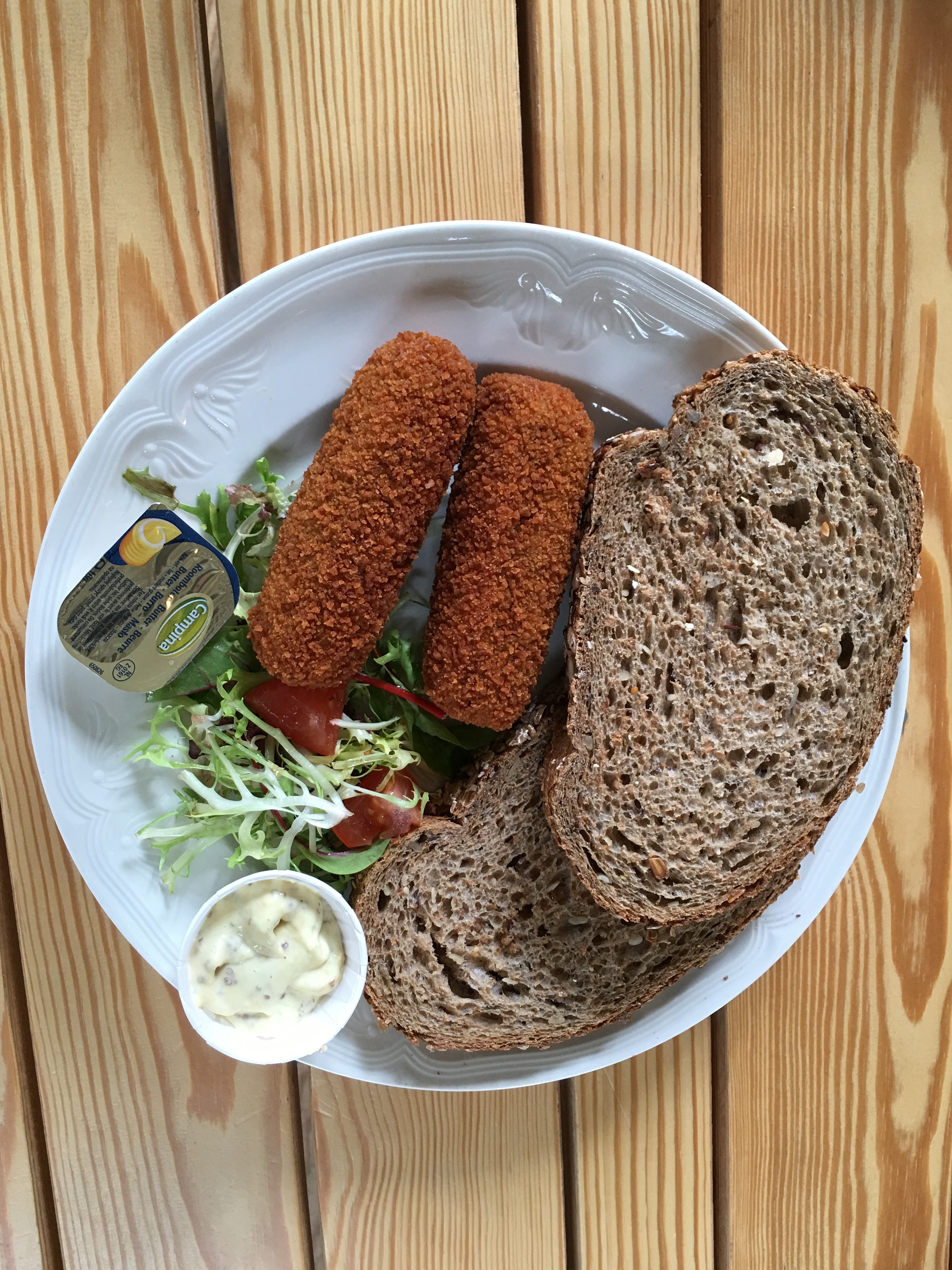 brown sliced bread beside deep fried food on white ceramic plate
