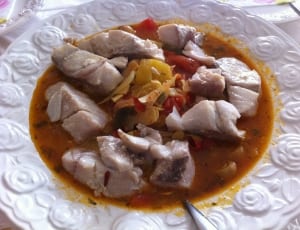 steamed meat cuts on orange soup with bell pepper strips thumbnail
