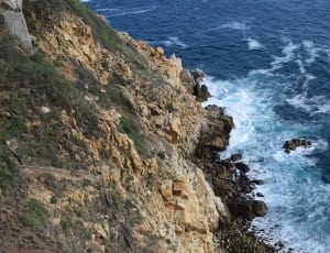 photograph of rocky cliff near ocean thumbnail