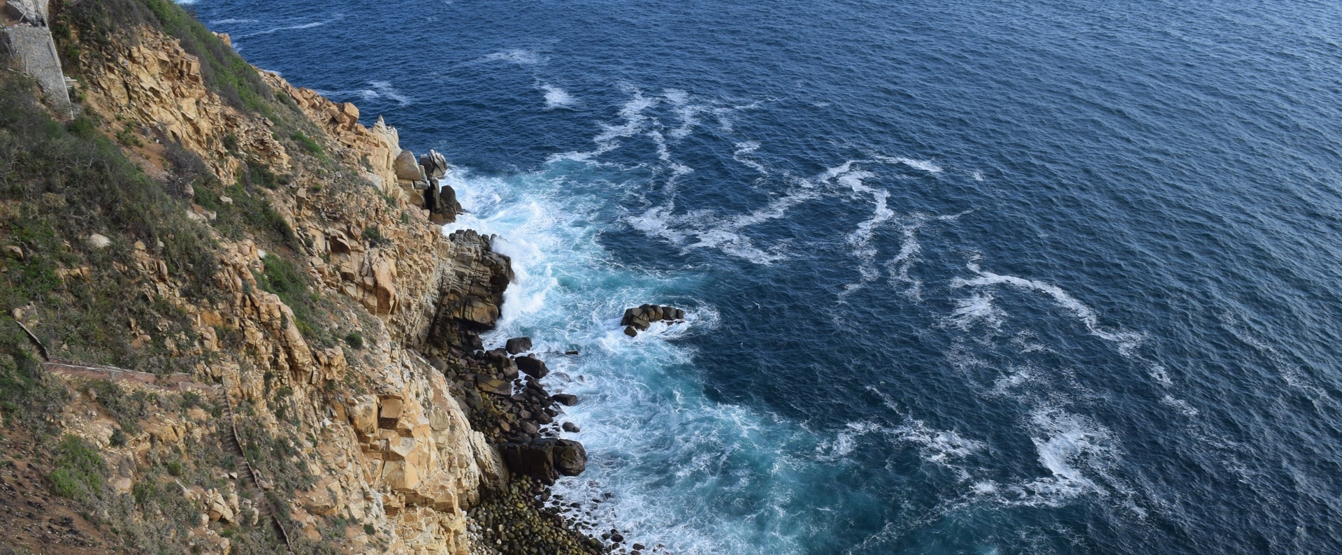 photograph of rocky cliff near ocean
