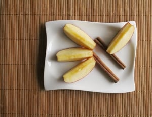 white rectangular ceramic plate with slice apple and sticks thumbnail