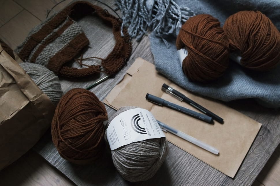 four yarns near three pens preview