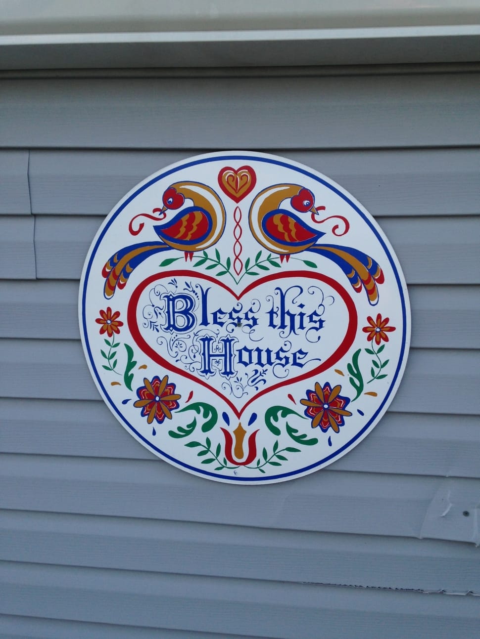 photo of round red and blue bless this home sign preview