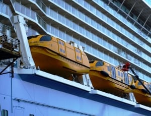 three orange inflatable boat on cruiser ship thumbnail