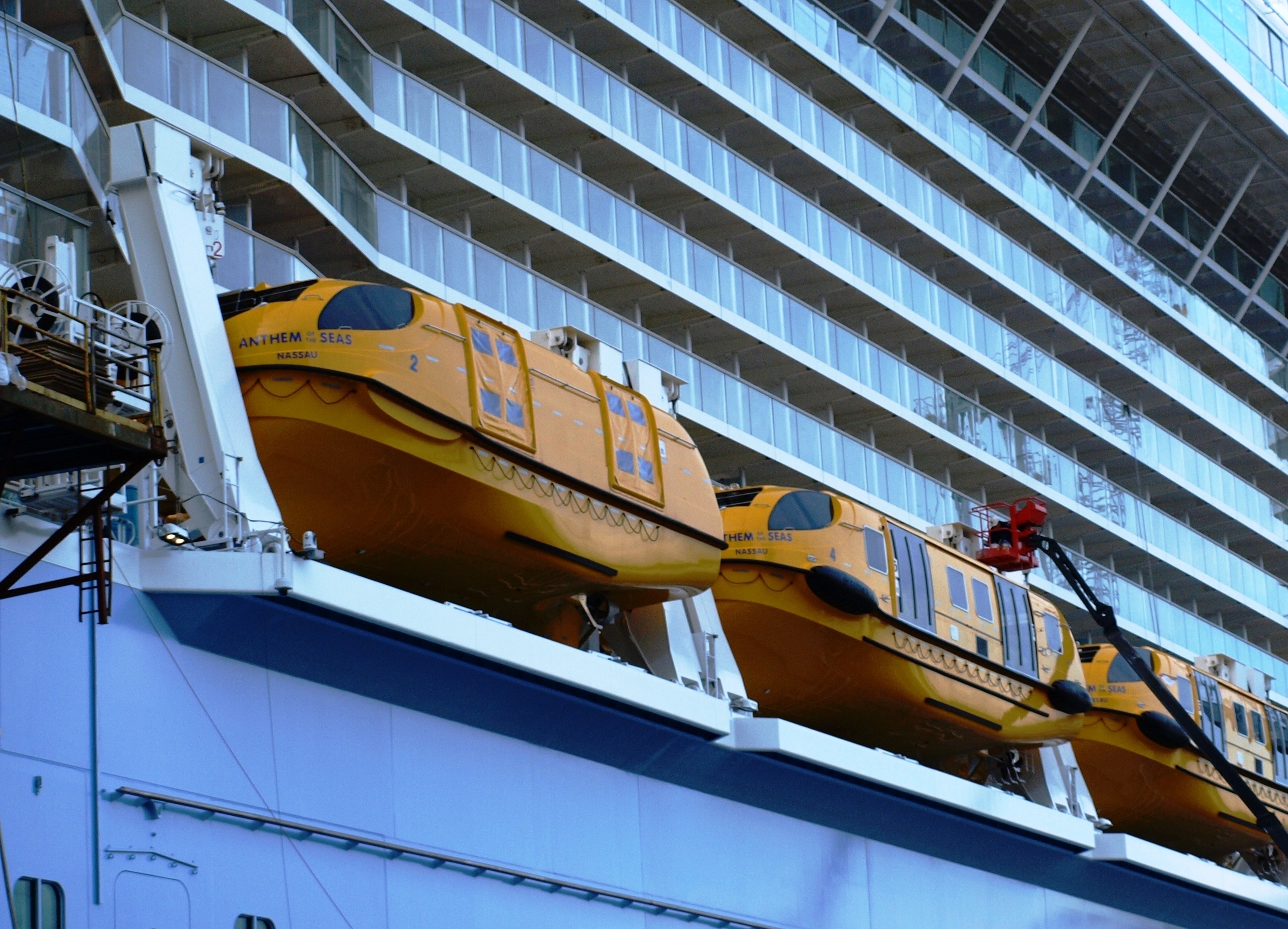 three orange inflatable boat on cruiser ship