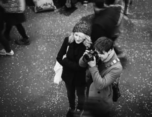 grayscale aerial photography of two person standing near to each other thumbnail