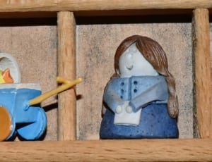 blue duck and woman figurines thumbnail