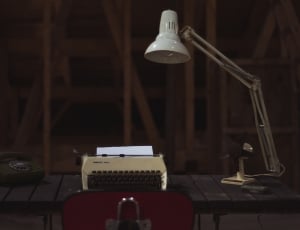study lamp near typewriter on top table thumbnail