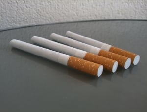 4 orange and white cigarette sticks thumbnail