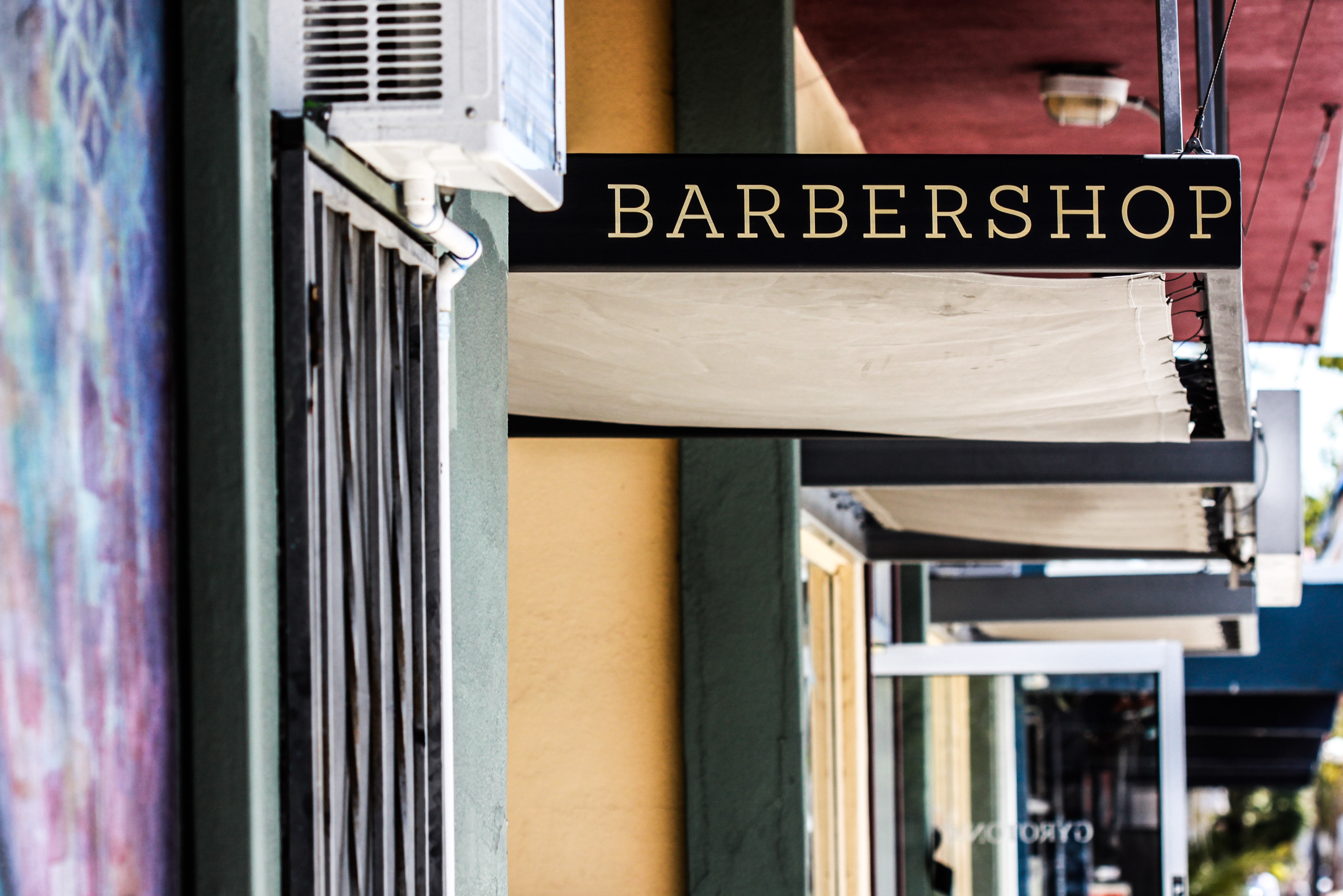 focus photography of barbershop signage